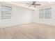 Bright bedroom with ceiling fan and wood-look floors at 15298 W Linden St, Goodyear, AZ 85338