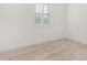 Simple bedroom with wood-look floors and window with shutters at 15298 W Linden St, Goodyear, AZ 85338