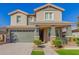 Two-story house with green garage doors and landscaping at 15298 W Linden St, Goodyear, AZ 85338