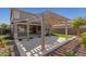 Covered patio with pergola, artificial turf, and gravel landscaping at 15298 W Linden St, Goodyear, AZ 85338