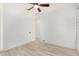 Light and airy bedroom with wood-look floors and door to hallway at 15298 W Linden St, Goodyear, AZ 85338