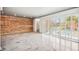 Living room showcasing exposed brick wall and concrete floors at 113 E Palm Ln # B, Phoenix, AZ 85004