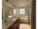 Bathroom with double sinks, bathtub, and shower at 3030 S 102Nd Ln, Tolleson, AZ 85353