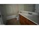 Bathroom with a tub, toilet and vanity with wood cabinets at 3030 S 102Nd Ln, Tolleson, AZ 85353
