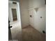 Bright laundry room with built-in shelving and tile flooring at 3030 S 102Nd Ln, Tolleson, AZ 85353