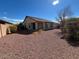 Backyard view of home with gravel and a tree at 3030 S 102Nd Ln, Tolleson, AZ 85353