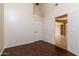Bright bedroom with dark wood flooring and double doors leading to another room at 851 N Pineview Dr, Chandler, AZ 85226
