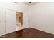 Spacious bedroom with dark wood floors and double doors to another room at 851 N Pineview Dr, Chandler, AZ 85226