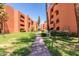 Brick pathway between two apartment buildings with green lawns at 12222 N Paradise Village S Pkwy # 442, Phoenix, AZ 85032