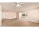 Living room with carpeted floor and access to sunroom at 10207 W Kingswood Cir, Sun City, AZ 85351