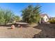 Large backyard with gravel landscaping, desert plants, and a view of the house at 26226 S Flame Tree Dr, Sun Lakes, AZ 85248