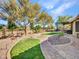 Landscaped backyard with stone pathways and grassy areas at 916 E Beautiful Ln, Phoenix, AZ 85042