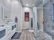 Modern bathroom with double sinks, a large shower, and modern fixtures at 916 E Beautiful Ln, Phoenix, AZ 85042