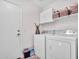 Convenient laundry room with washer, dryer, and storage shelves at 916 E Beautiful Ln, Phoenix, AZ 85042