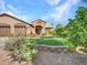 Single-story house exterior with a three-car garage and green lawn at 916 E Beautiful Ln, Phoenix, AZ 85042