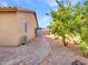 Side yard with stone pathway and small storage shed at 916 E Beautiful Ln, Phoenix, AZ 85042