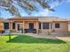 Covered patio with sectional sofa and view of grassy backyard at 916 E Beautiful Ln, Phoenix, AZ 85042