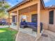 Covered patio with sectional sofa and string lights at 916 E Beautiful Ln, Phoenix, AZ 85042