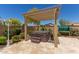 Relax in the backyard hot tub under a pergola at 5526 S Grenoble St, Mesa, AZ 85212