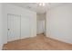 Bedroom with double door closet and access to hallway at 5526 S Grenoble St, Mesa, AZ 85212