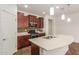 Eat-in kitchen with island, stainless steel appliances, and dark wood cabinetry at 5526 S Grenoble St, Mesa, AZ 85212