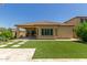 Home features a backyard with artificial turf, paved patio, and a covered patio at 5526 S Grenoble St, Mesa, AZ 85212