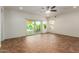 Living room with tile floors, sliding glass doors, and ceiling fan at 5526 S Grenoble St, Mesa, AZ 85212