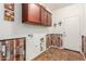 Laundry room with wood-look wall and upper cabinets at 5526 S Grenoble St, Mesa, AZ 85212
