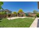 Spacious backyard with hot tub, pergola, and artificial turf at 5526 S Grenoble St, Mesa, AZ 85212