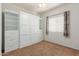 Well-lit bedroom featuring a wall bed and storage at 5526 S Grenoble St, Mesa, AZ 85212