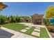 Spacious backyard with artificial turf and a hot tub under a pergola at 5526 S Grenoble St, Mesa, AZ 85212