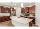 Kitchen features a large island with seating, stainless steel appliances, and ample cabinetry at 5526 S Grenoble St, Mesa, AZ 85212