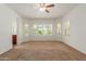 Bright bedroom with ceiling fan, large windows, and neutral carpet at 5526 S Grenoble St, Mesa, AZ 85212