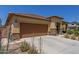 Tan house with brown garage door and stone accents at 5526 S Grenoble St, Mesa, AZ 85212