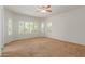 Well-lit bedroom with ceiling fan, plantation shutters, and neutral carpet at 5526 S Grenoble St, Mesa, AZ 85212