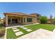 Home features a backyard with artificial turf, paved patio, and a covered patio at 5526 S Grenoble St, Mesa, AZ 85212