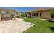 Artificial turf and a pergola with hot tub highlight the backyard at 5526 S Grenoble St, Mesa, AZ 85212
