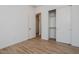 Bedroom with wood-look tile floors and sliding closet doors at 1356 E Cherrywood Pl, Chandler, AZ 85249