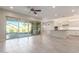 Kitchen with an island, white cabinets, and sliding glass doors to backyard at 43958 W Stonecreek Rd, Maricopa, AZ 85139