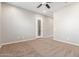 Carpeted bedroom with ceiling fan and neutral walls at 43958 W Stonecreek Rd, Maricopa, AZ 85139