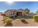 View of home's back elevation and landscaped yard at 43958 W Stonecreek Rd, Maricopa, AZ 85139