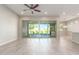 Open concept kitchen with island, white cabinets, and access to backyard patio at 43958 W Stonecreek Rd, Maricopa, AZ 85139