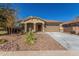 Tan two-car garage home with desert landscaping at 43958 W Stonecreek Rd, Maricopa, AZ 85139