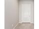 Light and airy entryway with white door and grey tile flooring at 43958 W Stonecreek Rd, Maricopa, AZ 85139