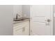 Convenient laundry area with utility sink and cabinets at 43958 W Stonecreek Rd, Maricopa, AZ 85139