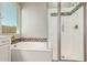 Modern bathroom featuring a shower and bathtub at 43958 W Stonecreek Rd, Maricopa, AZ 85139