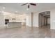 Open living room with tile floors and access to kitchen at 43958 W Stonecreek Rd, Maricopa, AZ 85139