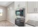 Built-in microwave and oven in modern kitchen at 43958 W Stonecreek Rd, Maricopa, AZ 85139