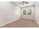 Spacious bedroom with neutral wall color, ceiling fan, and carpet flooring at 43958 W Stonecreek Rd, Maricopa, AZ 85139