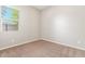 Spacious bedroom with carpeted floor and large window at 43958 W Stonecreek Rd, Maricopa, AZ 85139